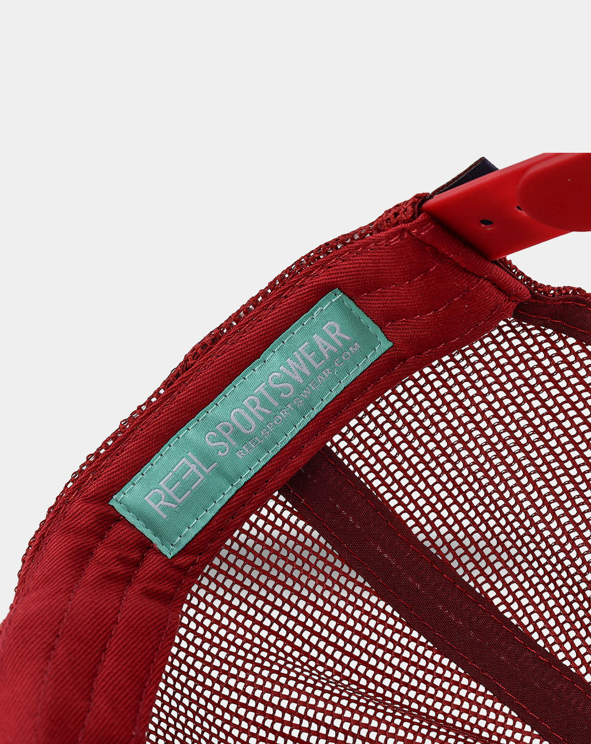 Reel Sportswear Dawson Trucker Hat — interior teal RS branded label sewn into red mesh panel