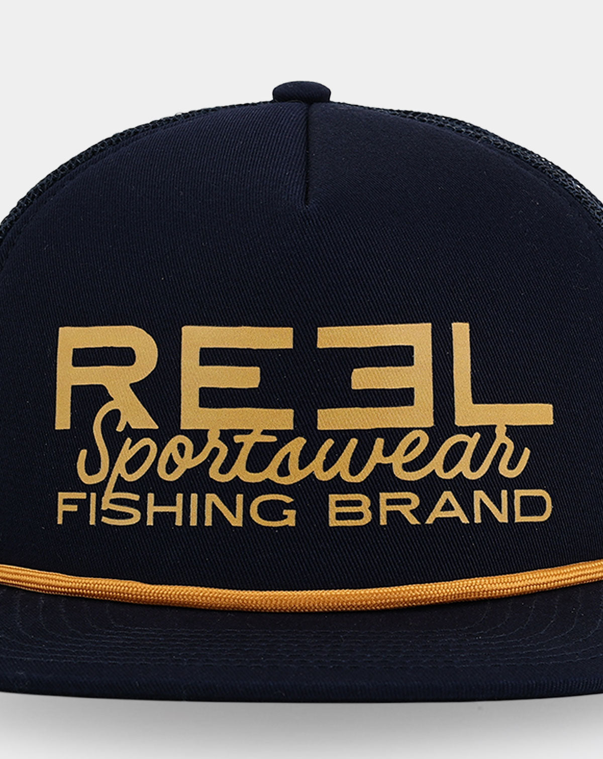 Reel Sportswear Oilman Trucker Hat — close-up of oversized gold Reel Sportswear Fishing Brand logo on dark structured front panel