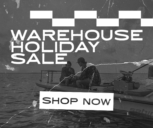 Two people in a boat on water with 'Warehouse Holiday Sale' text overlay, Reel Sportswear Holiday Warehouse sale, best prices on fishing apparel