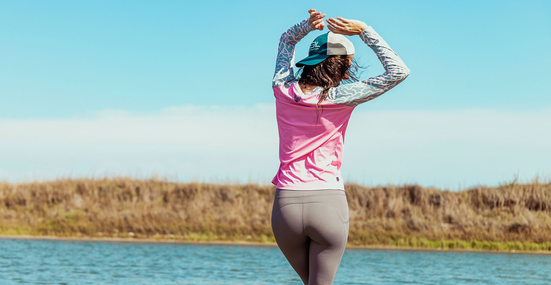Jasmine women's longsleeve fishing shirt. women's performance shirts, woman dancing on the bay