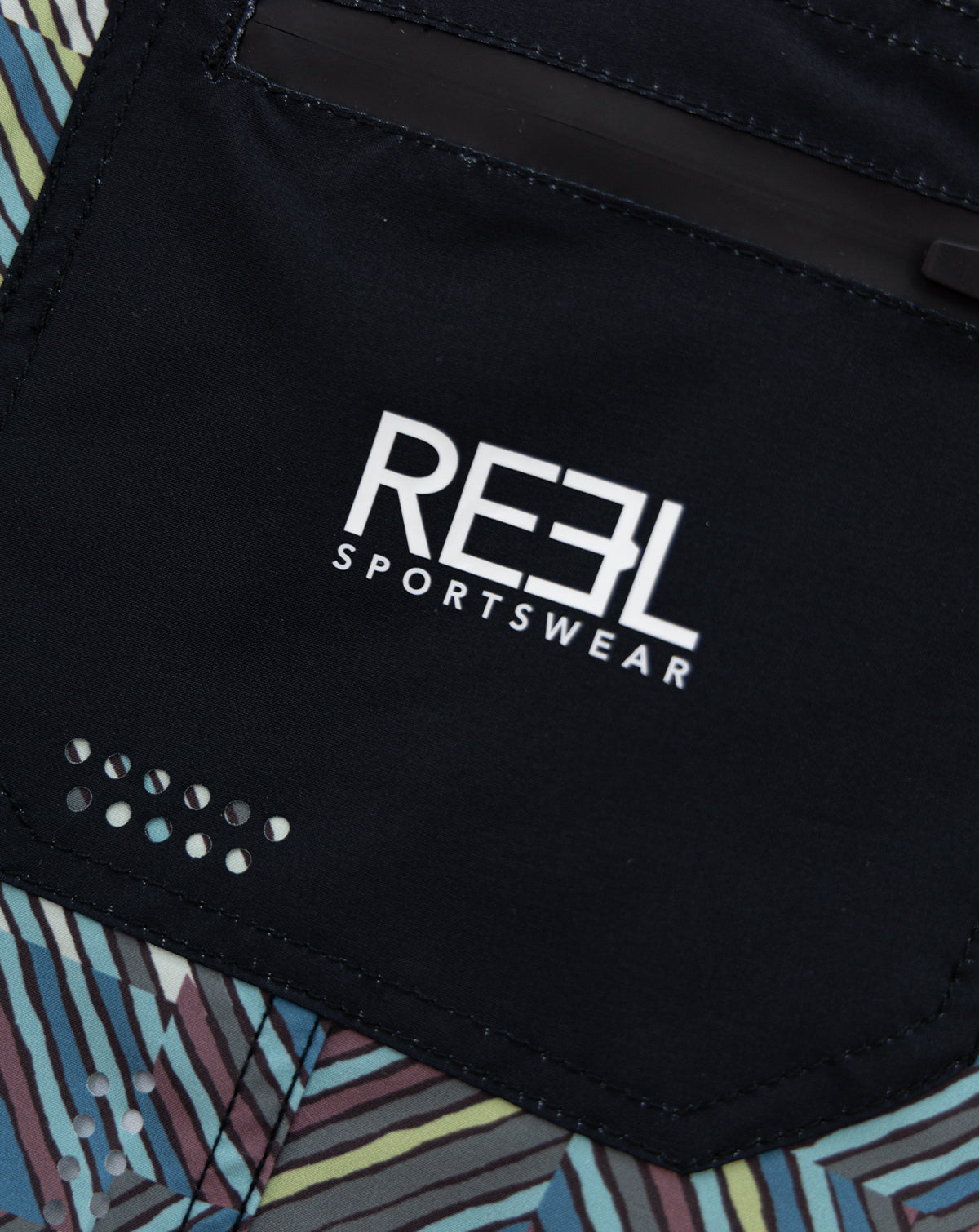 Multi-colored and black Lunkerbunker boardshorts for men with a stylish design, featuring UPF30+ 4-way stretch fabric, quick-dry technology, anti-microbial properties, fixed waist, double bonded butt seam for added strength, side zipper pocket, laser cut holes, 21" outseam and side patch pockets for ultimate fishing performance.